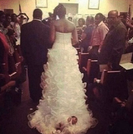 baby tied to a wedding dress