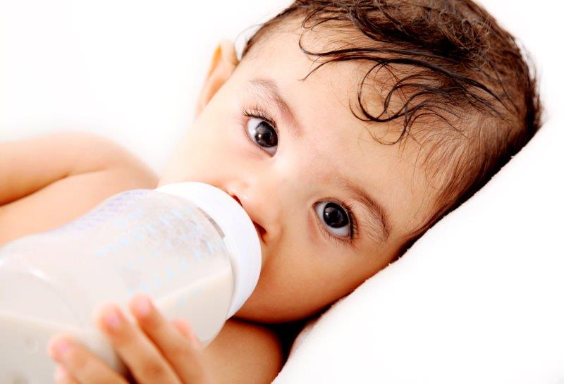 baby drinking a bottle of formula