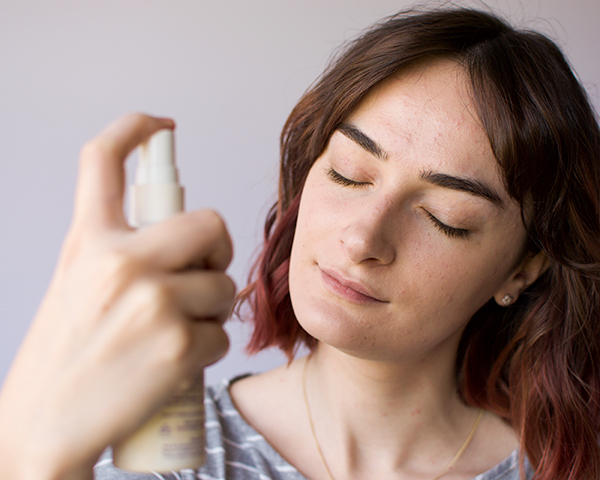 applying facial mist to dry skin