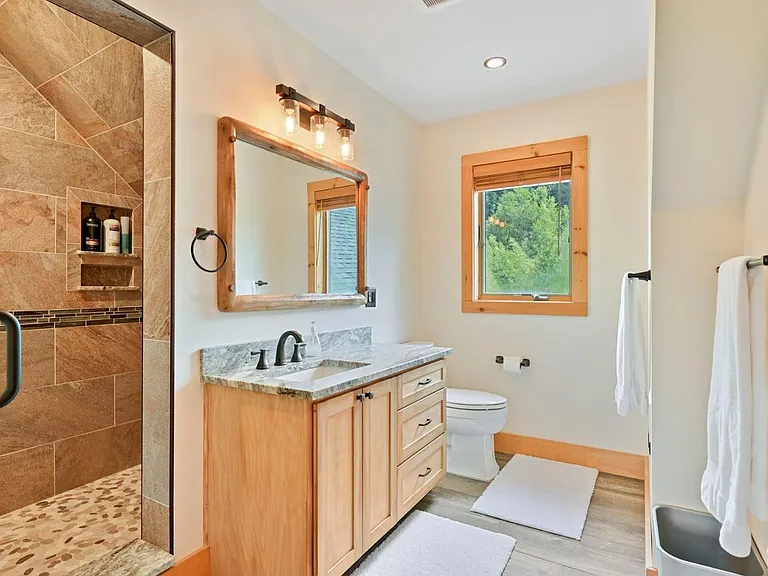 Hunter Mountain, NY ski chalet, log cabin bathroom with local granite vanity and live edge wood cabinetry