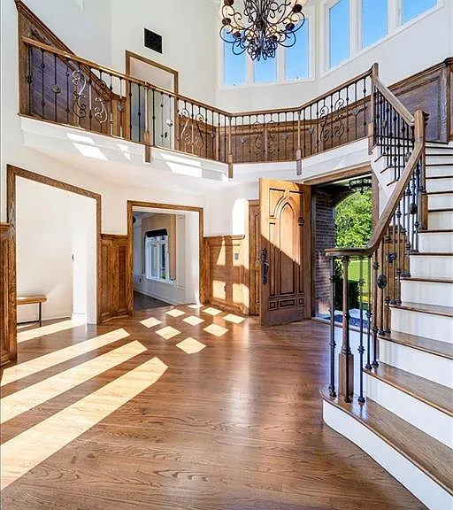 Wappingers Falls NY mansion compound overlooking the Hudson River, wood foyer with massive ceilings and wood detailed large staircase