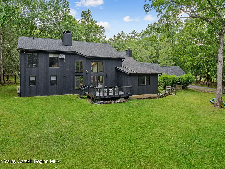 Woodstock NY retreat on 2.58 acres with landscaped exterior and black paint