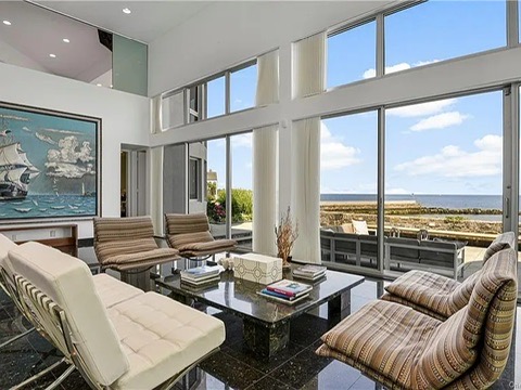 New Rochelle beach house in New York, living room with black tile floors and a conversation pit overlooking the Long Island Sound