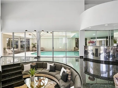 New Rochelle beach house in New York, living room with black tile floors and a conversation pit overlooking the Long Island Sound