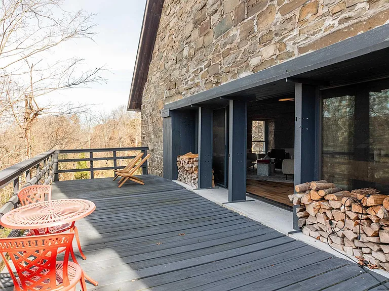 Ulster Park, NY Church turned residential home, exterior with charcoal deck and stacked firewood