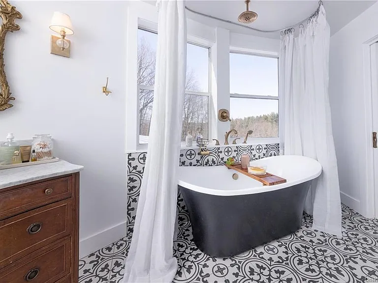 hudson valley yurt house, renovated yurt bathroom with spanish tile and a soaking tub