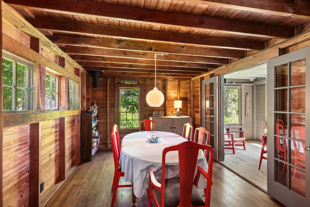 Rustic Maine Beach House, exposed natural wood beams in a vintage dining room