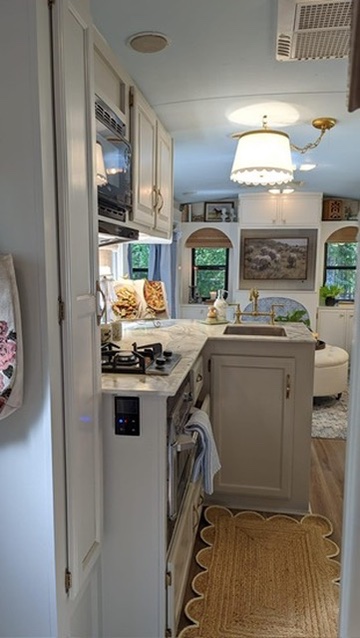 renovated camper, french countryside and southern belle design with an updated white kitchen