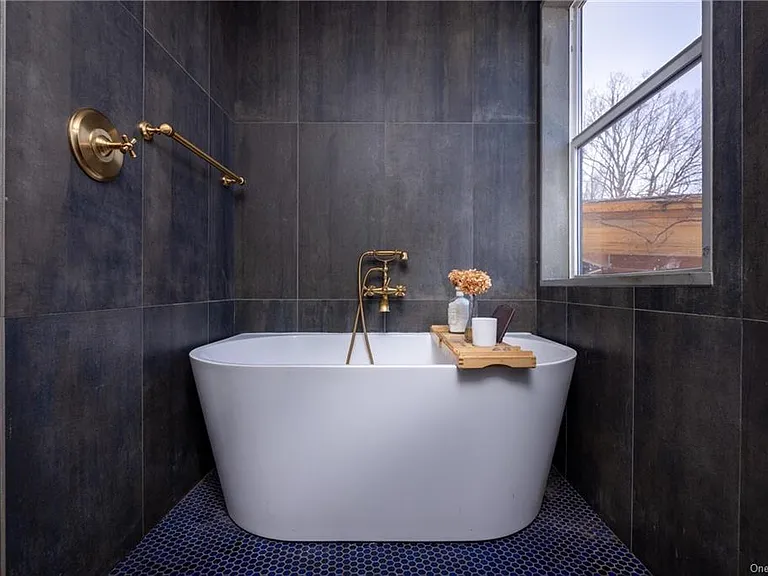 hudson valley yurt house, renovated yurt bathroom with spanish tile and a soaking tub