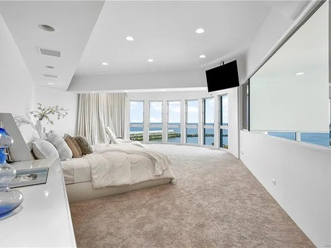 New Rochelle beach house in New York, vintage carpeted bedroom with views of the Long Island Sound