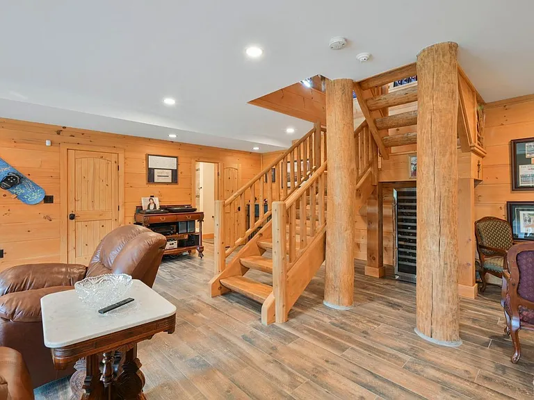 Hunter Mountain, NY ski chalet, natural wood home bar and entertainment room log staircase