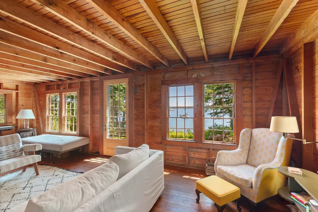 Rustic Maine Beach House, exposed natural wood beams living room with light furniture