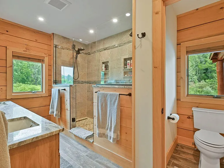 Hunter Mountain, NY ski chalet, log cabin bathroom with local granite vanity and live edge wood cabinetry