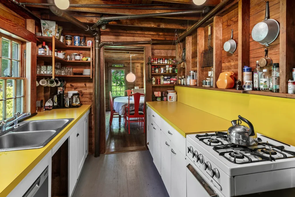 Rustic Maine Beach House, exposed natural wood beams in a vintage galley kitchen