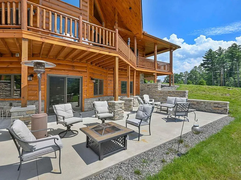 Hunter Mountain, NY ski chalet, exterior sitting area with a paved back patio overlooking hunter mountain and tannersville