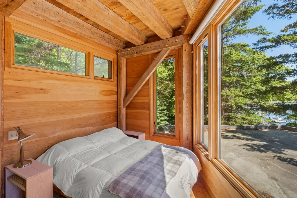 Rustic Maine Beach House, exposed natural wood bedroom facing the atlantic ocean