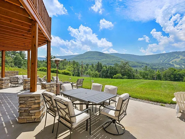 Hunter Mountain, NY ski chalet, exterior sitting area with a paved back patio overlooking hunter mountain and tannersville