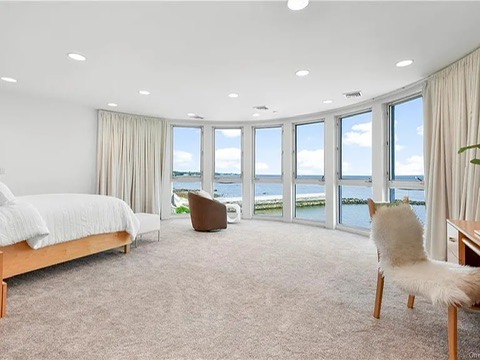 New Rochelle beach house in New York, vintage master bedroom with walk in closets and ensuite bathroom facing the Long Island Sound