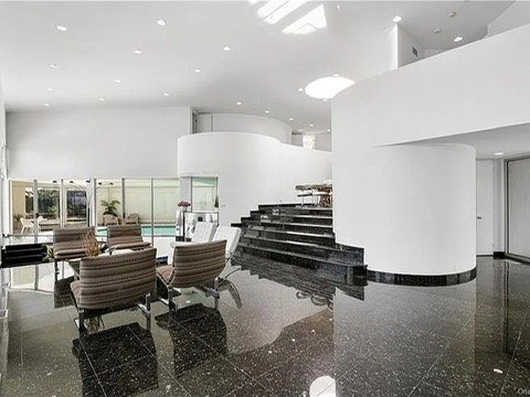 New Rochelle beach house in New York, living room with black tile floors and a conversation pit overlooking the Long Island Sound