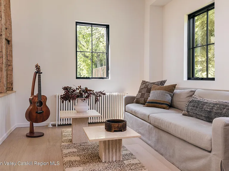 Highland, NY estate with neutral colors, neutral modern living room with ornamental guitar