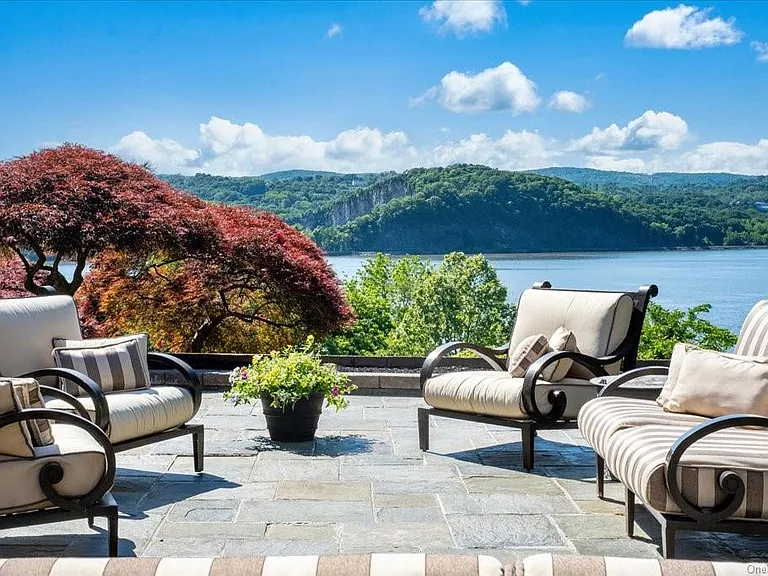 Wappingers Falls NY mansion compound overlooking the Hudson River, bluestone patio with outdoor furniture overlooking the hudson river