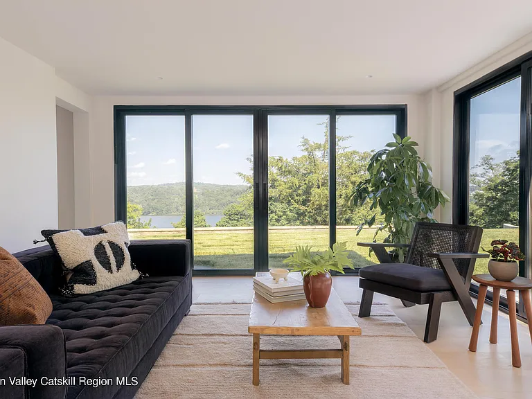 Highland, NY estate with neutral colors, neutral modern living room with views of the Hudson River