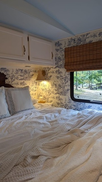 renovated camper, french countryside and southern belle design with a floral and toile master bedroom space