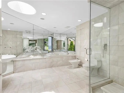 New Rochelle beach house in New York, vintage master bedroom with massive tile soaking tub and glass shower