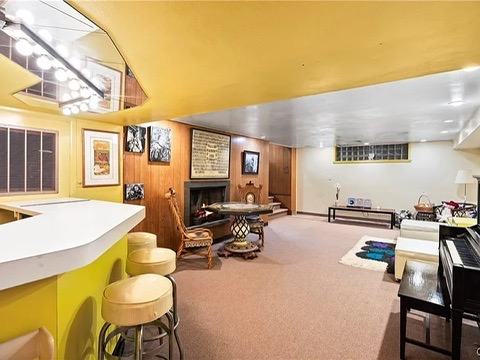 vintage MCM Fayetteville, NY house for sale with retro details, midcentury den with seating area and built-in bar