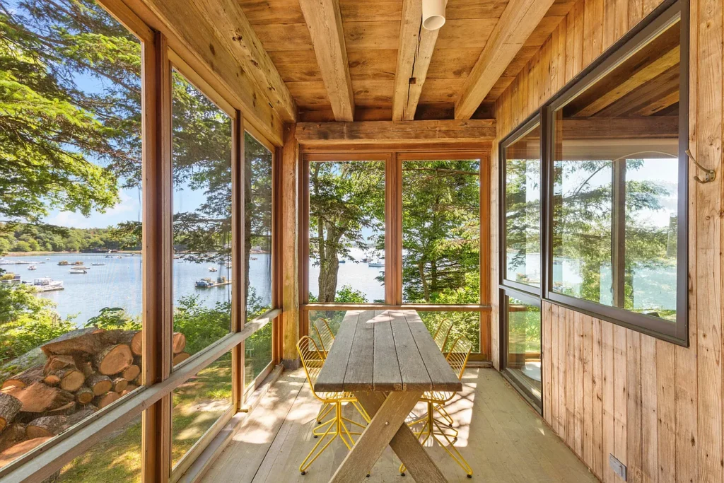 Rustic Maine Beach House, exposed natural wood screened in porch with live edge picnic table