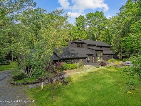 woodstock, ny retreat, exterior of property with natural pond and green grass