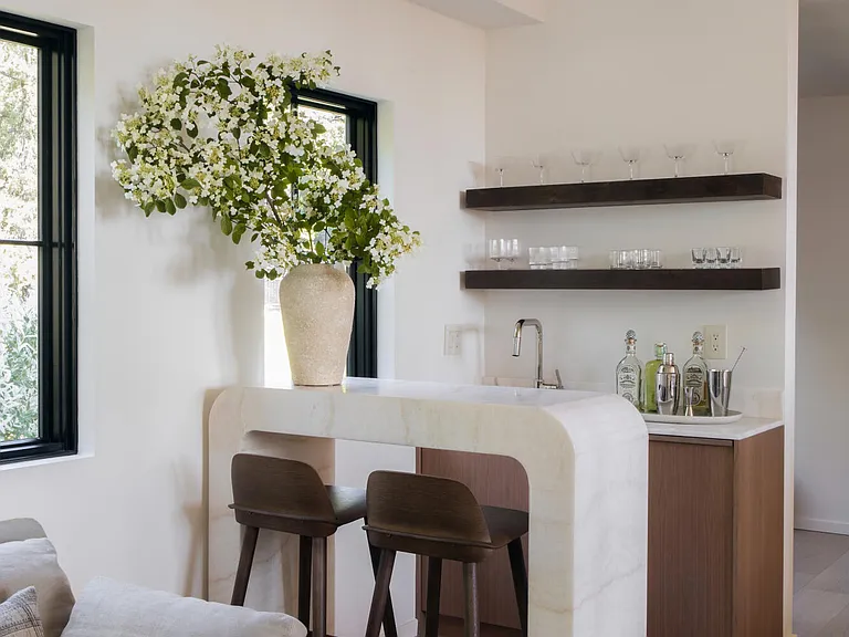 Highland, NY estate with neutral colors, neutral modern bar space with bar stools