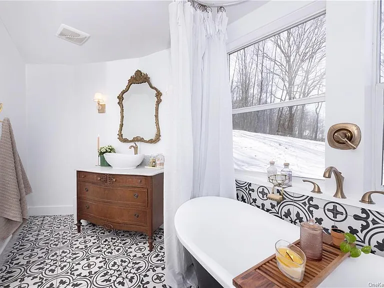 hudson valley yurt house, renovated yurt bathroom with spanish tile and a soaking tub