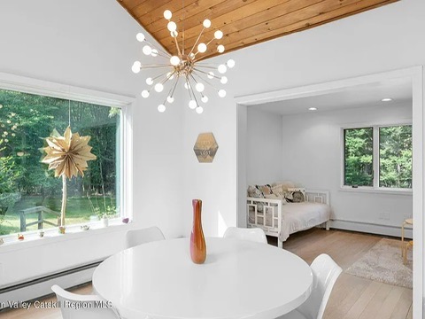 woodstock, ny retreat, giant vaulted ceilings with natural wood finish eat in kitchen with modern light fixture