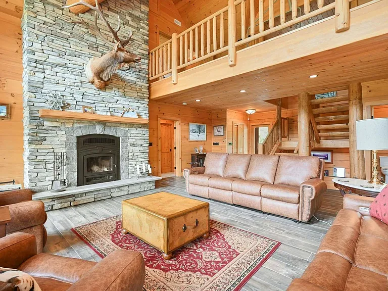 Hunter Mountain, NY ski chalet, log cabin with vaulted ceilings living room and a taxidermy deer head