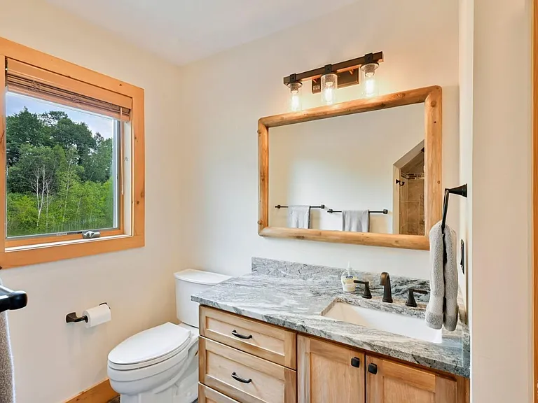 Hunter Mountain, NY ski chalet, log cabin bathroom with local granite vanity and live edge wood cabinetry