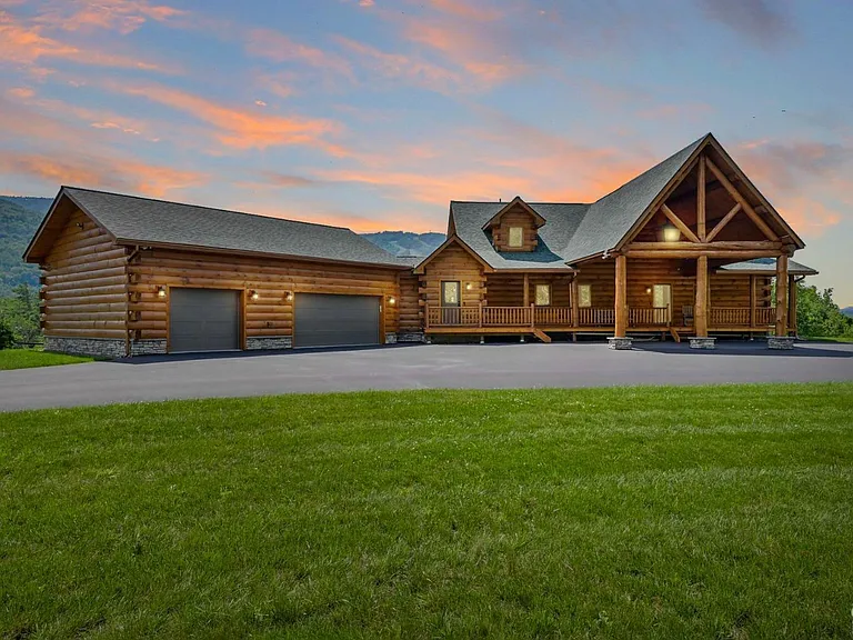 Hunter Mountain, NY ski chalet, log cabin exterior with circular driveway at dusk