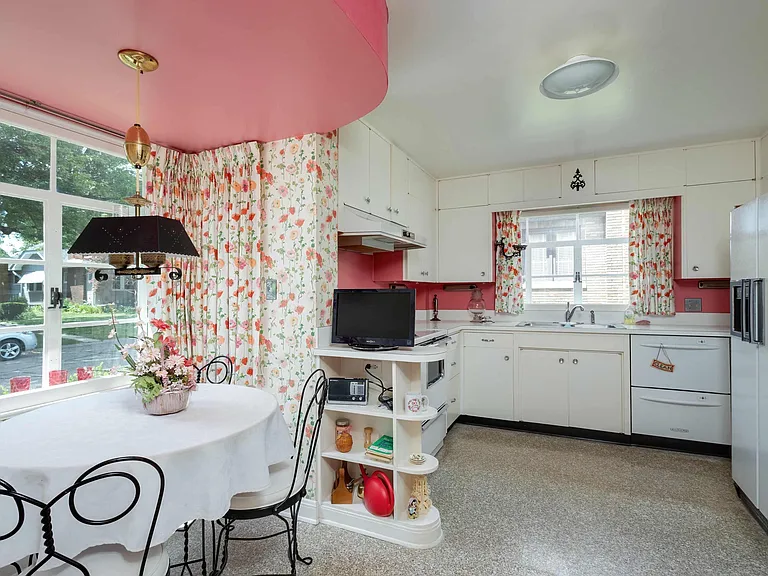 vintage Rock Island Illinois house, vintage floral wallpaper kitchen with retro pink formica and white cabinets