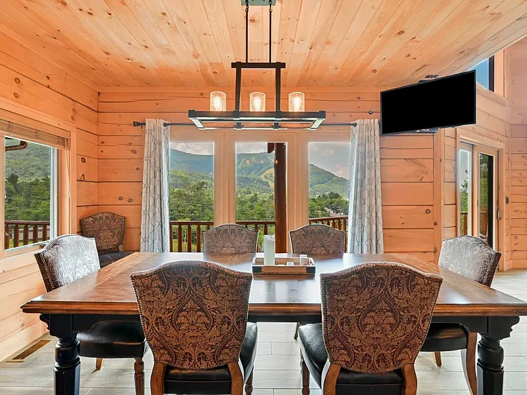 Hunter Mountain, NY ski chalet, log cabin dining room with extra long dining table in live-edge wood