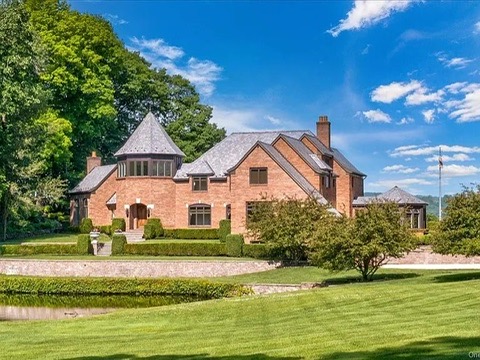 Wappingers Falls NY mansion compound overlooking the Hudson River, brick exterior with lush green landscaping