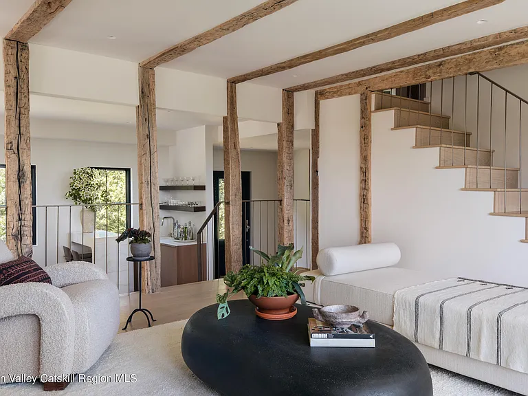 Highland, NY estate with neutral colors, neutral modern living room with exposed beams