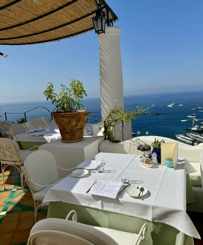 positano beach, outdoor dining facing the water in positano