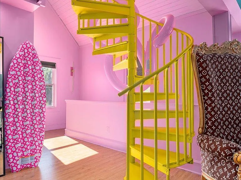 all-pink Barbie Dream House for sale, pink walls and a yellow spiral staircase