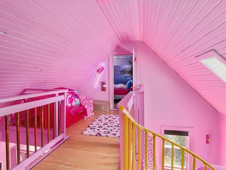 all-pink Barbie Dream House for sale, pink walls and a yellow spiral staircase