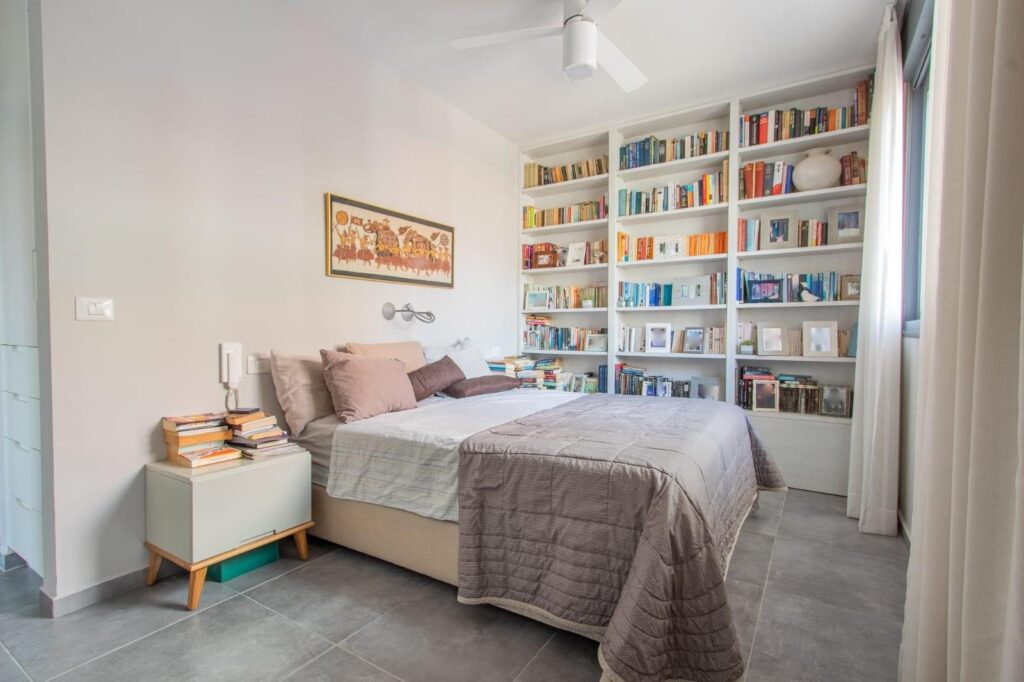 light bright rooms, bedroom with multicolor bookshelves and soft, muted bedding