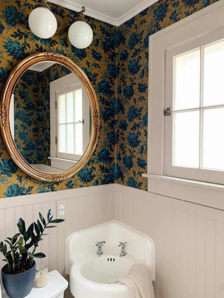 light bright rooms, bathroom with gilded mirror, white fixtures and jewel tone wallpaper