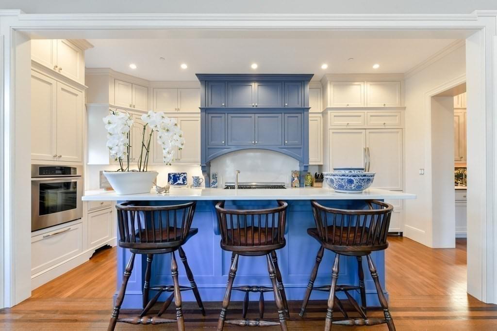 light bright rooms, sun filled kitchen with tall white and navy blue cabinetry and black detailing