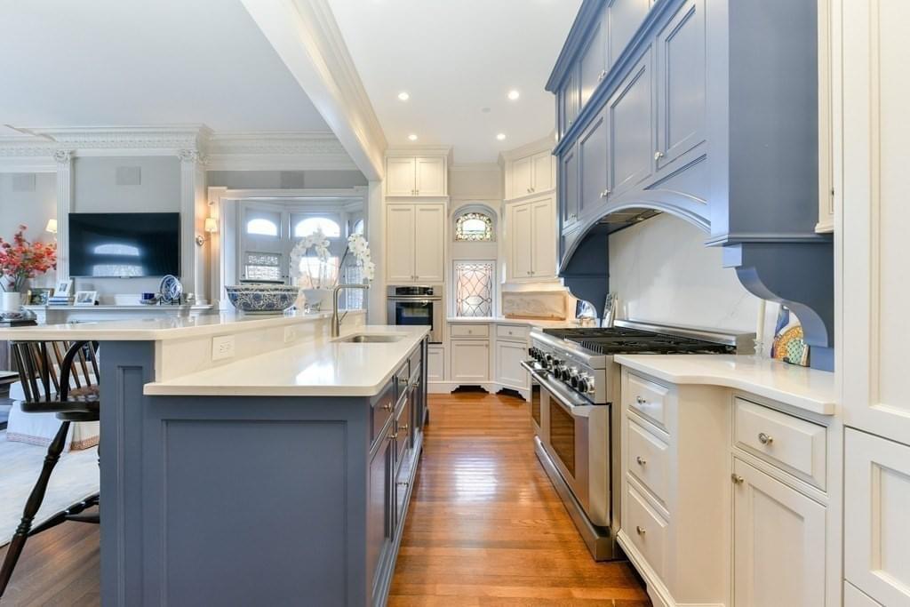 light bright rooms, sun filled kitchen with tall white and navy blue cabinetry and black detailing