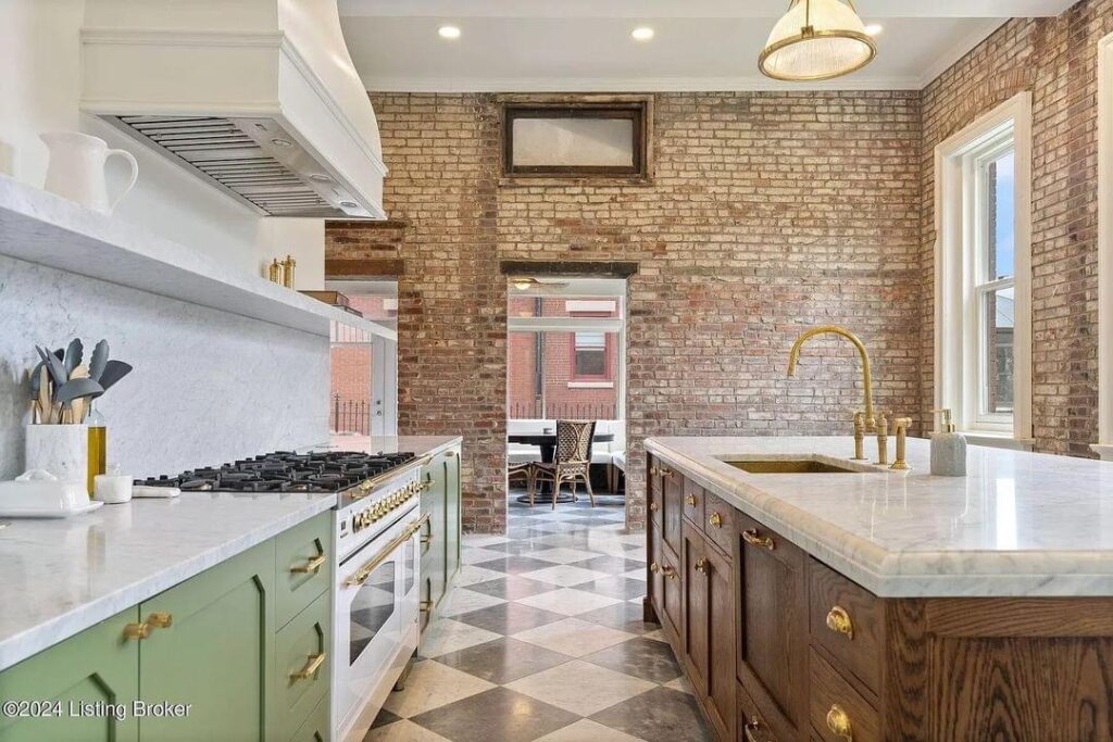 light bright rooms, sage green kitchen cabinets with checkerboard tile floors and wood with white marble center island and white and gold stove