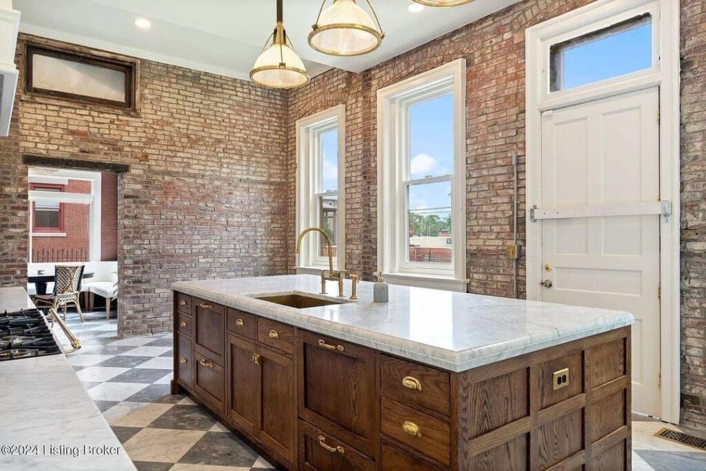 light bright rooms, sage green kitchen cabinets with checkerboard tile floors and wood with white marble center island and white and gold stove